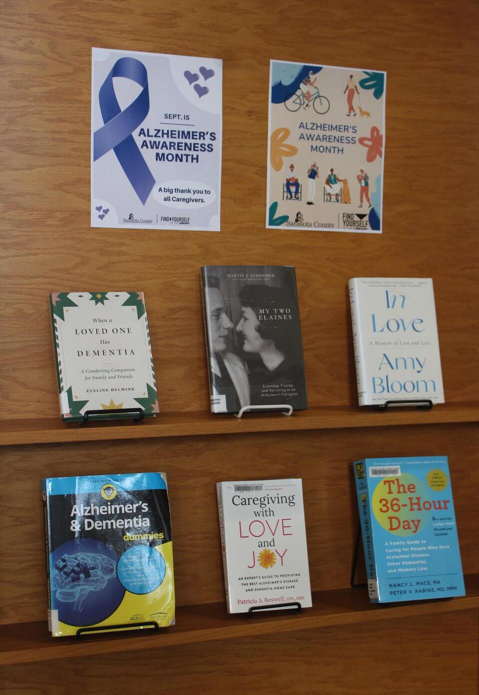 A door display featuring caregiver books fanned out alongside Alzheimer's Awareness Month posters.